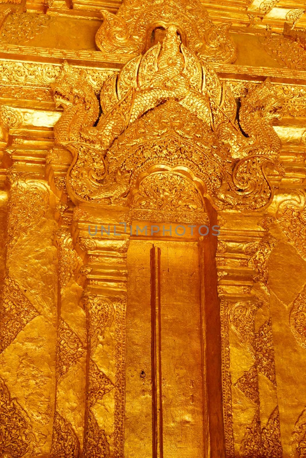 the high detail of square hall with pyramidal roof that made by real gold plate and decorated by craving thai pattern,Lampang temple,Thailand