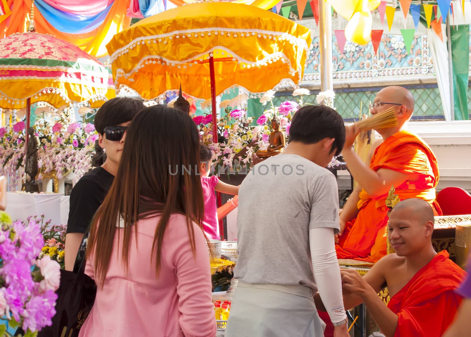 BANGKOK-APRIL 16:Unidentified monk pouring a holy water to people for a good luck in Songkran festival tradition of thailand. 
April 16,2014 in Bangkok ,Thailand