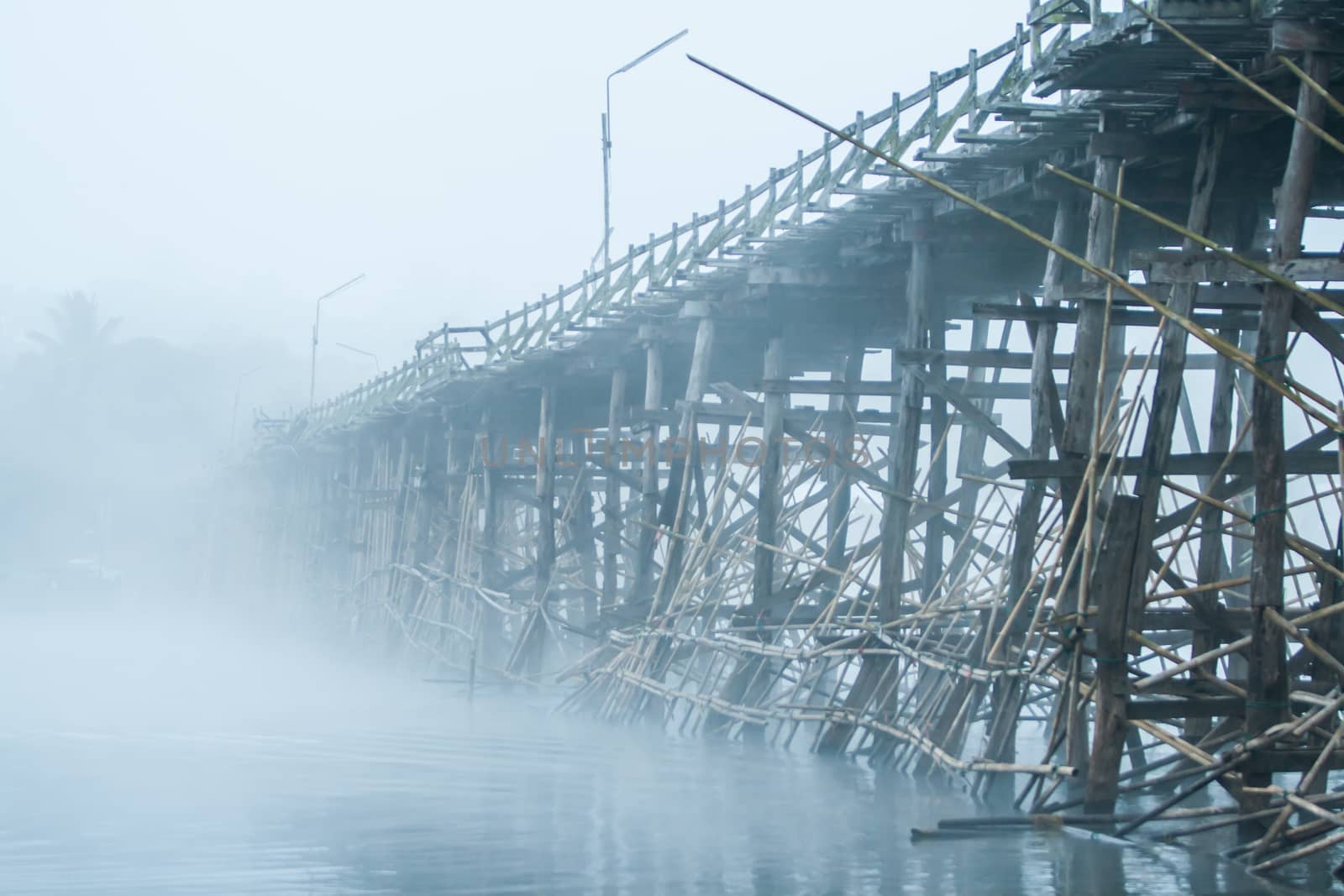 Wooden bridge with the fog in winter.