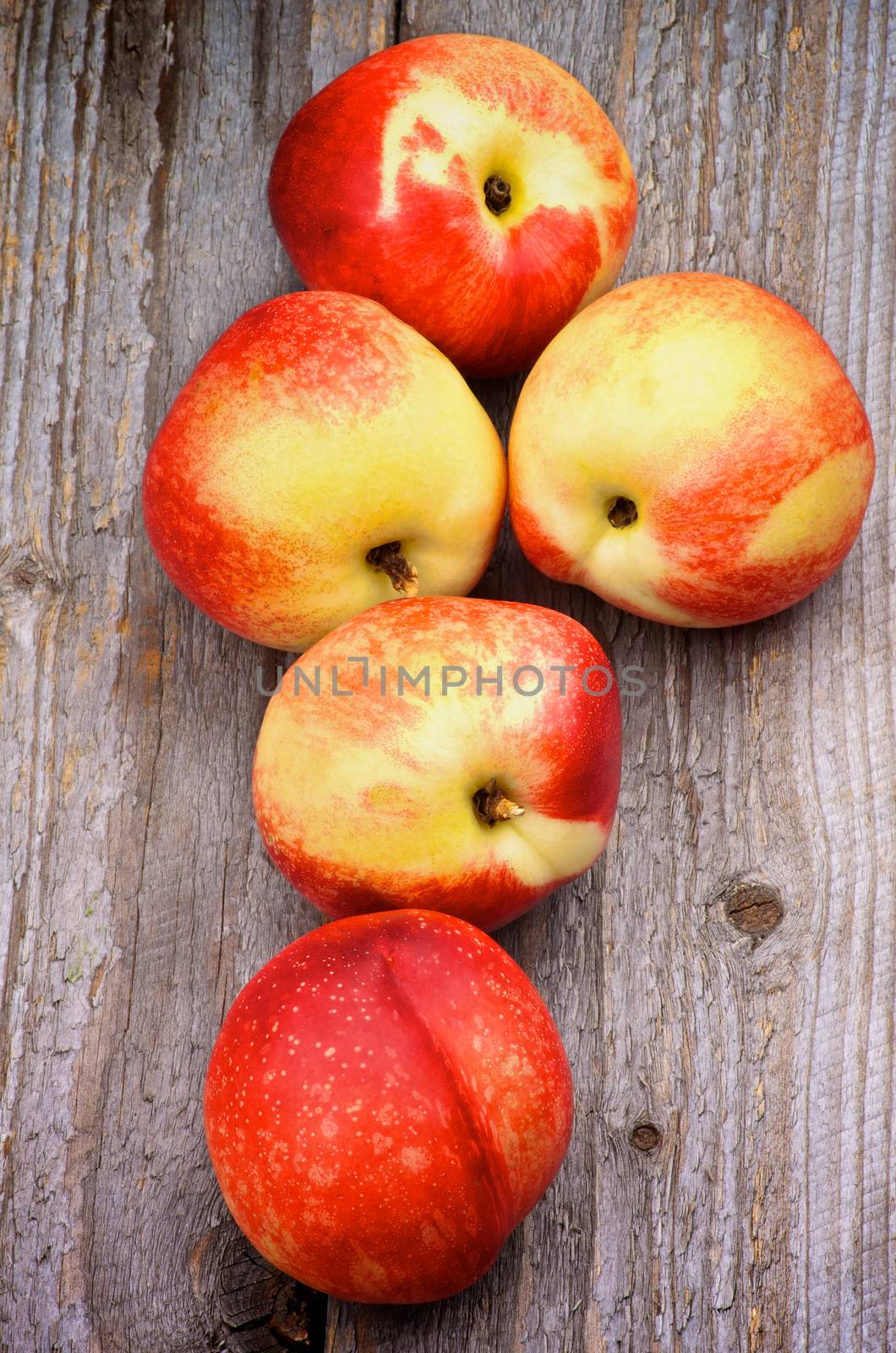 Heap of Perfect Ripe Nectarines In a Row on Rustic Wooden background. Top View