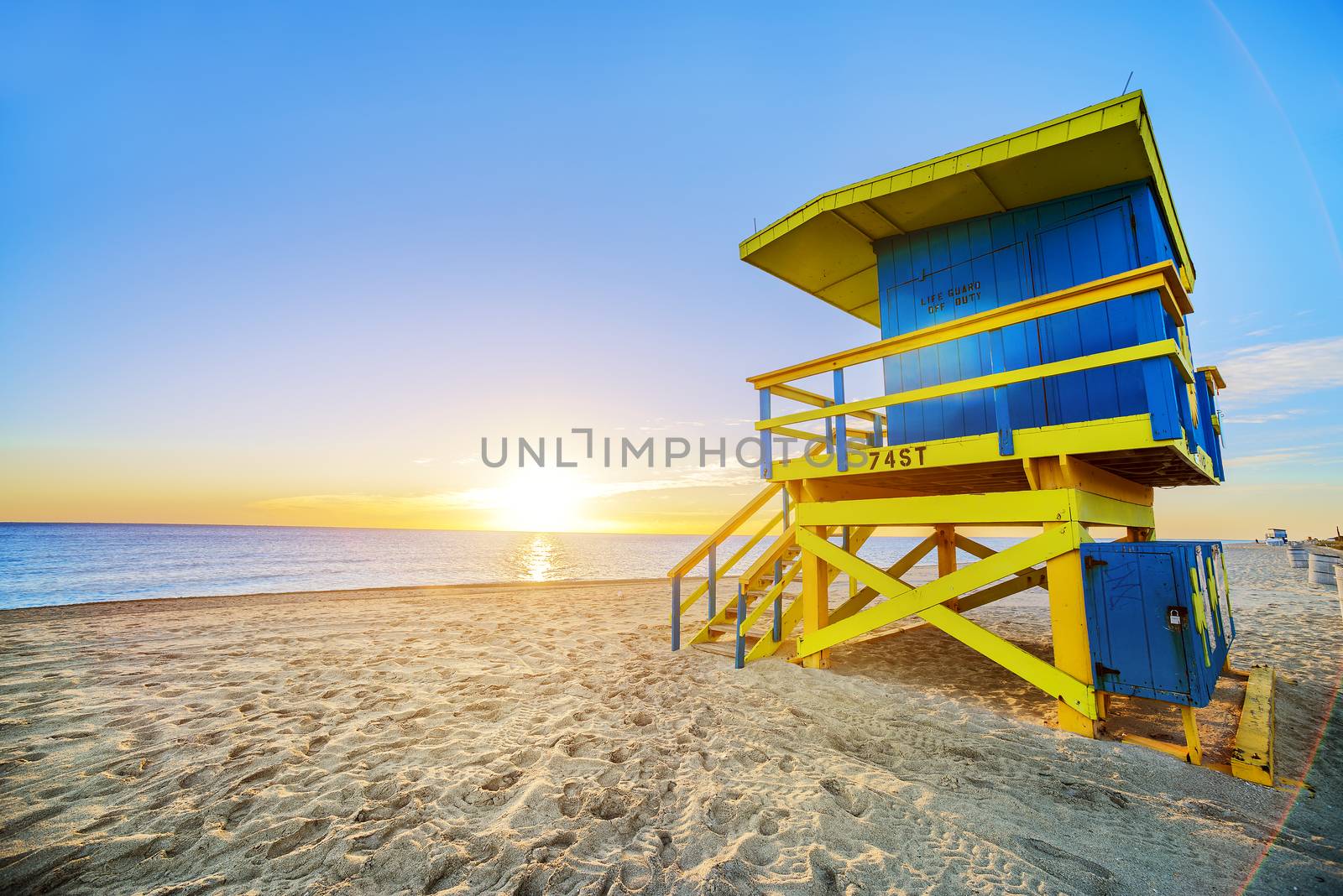 Miami South Beach sunrise with lifeguard tower and coastline with colorful cloud and blue sky. 