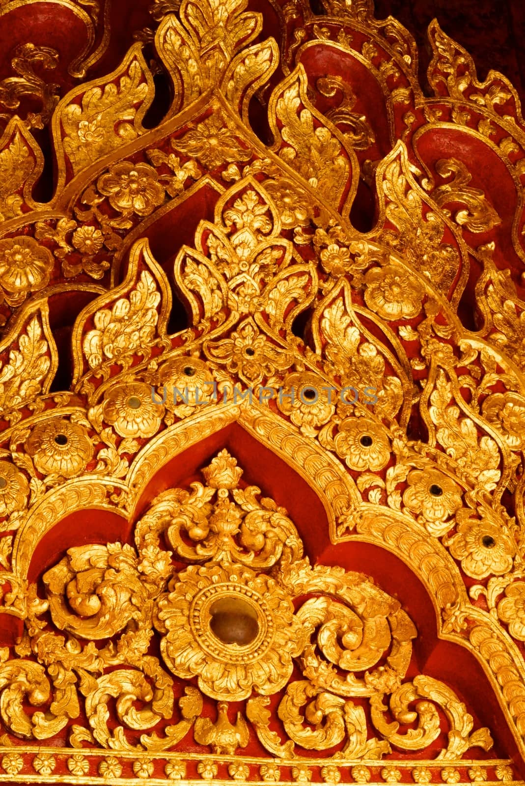 high complicated stucco work showing of traditional thai pattern that decorated with mirror and precious stone,Lampang temple,Thailand