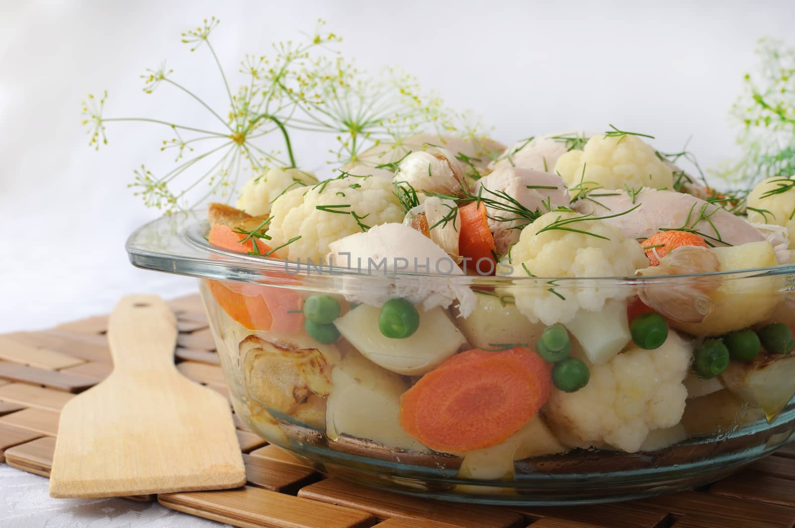 Roasted vegetables with slices of chicken and fennel in a pan