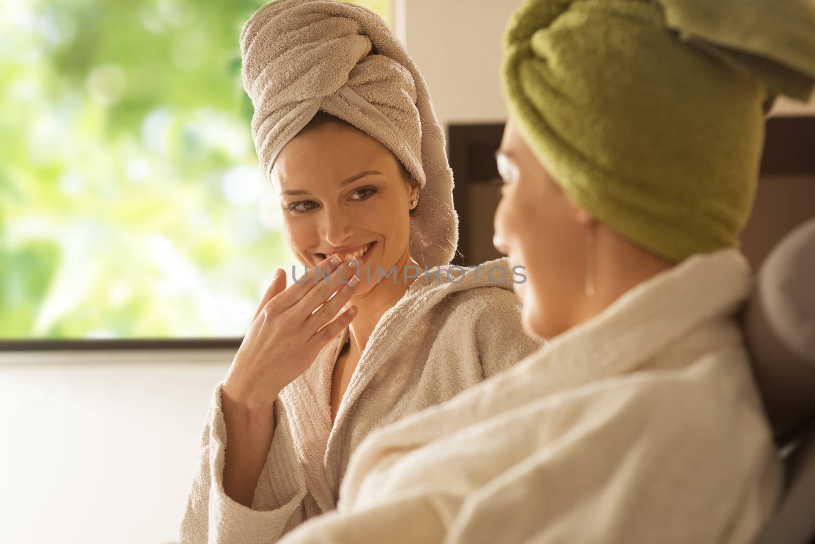 Women enjoying spa treatments. by stokkete