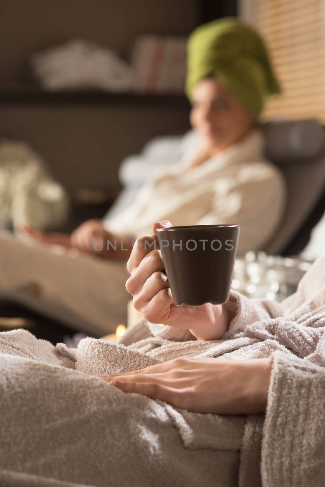 Beautiful women enjoying spa treatments, cup close up.