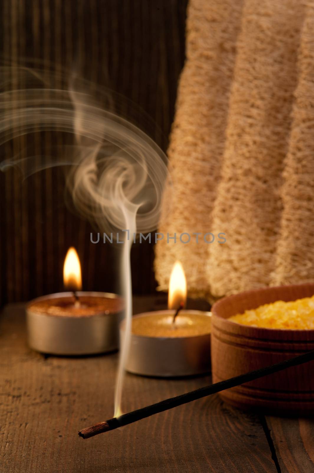 Spa setting and fuming aroma stick on dark wooden background