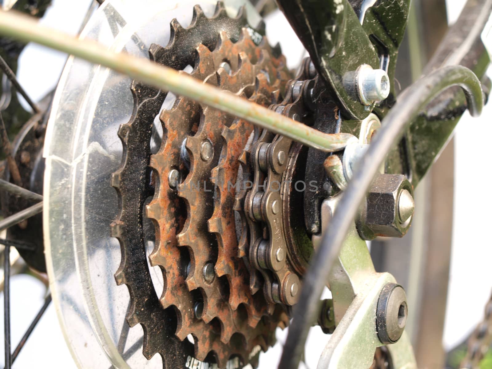 Close up of rusty bicycle gears and chain.