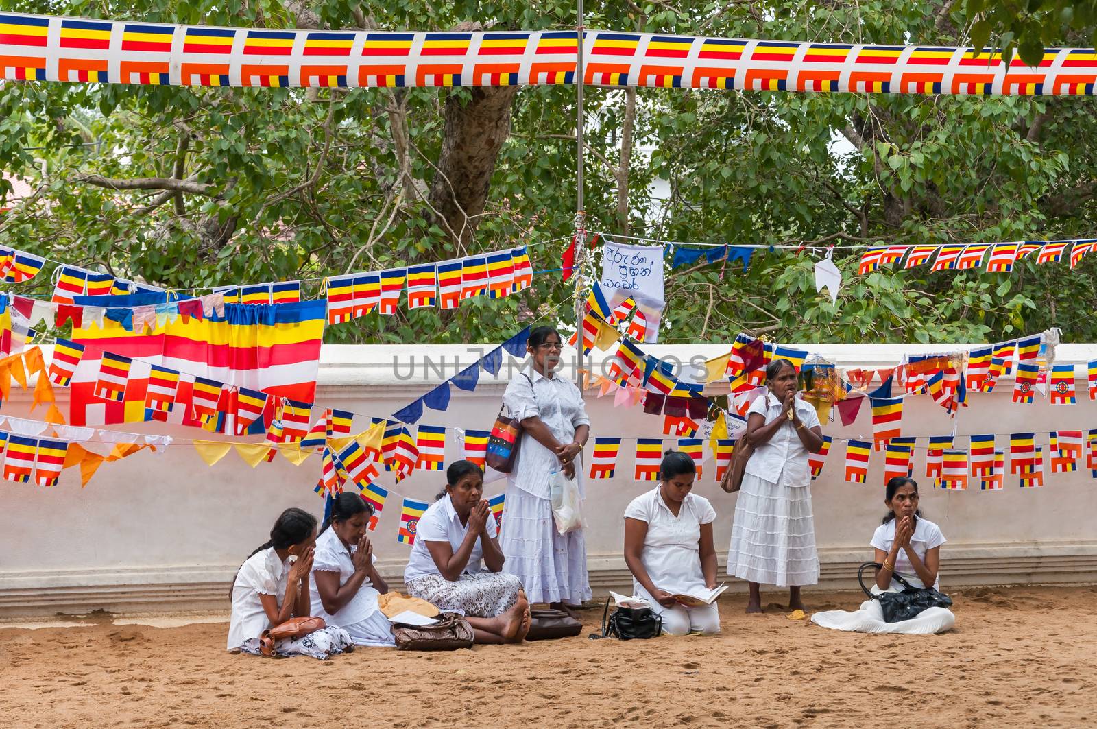 Sri Lankan women pray at buddhist temple by mkos83