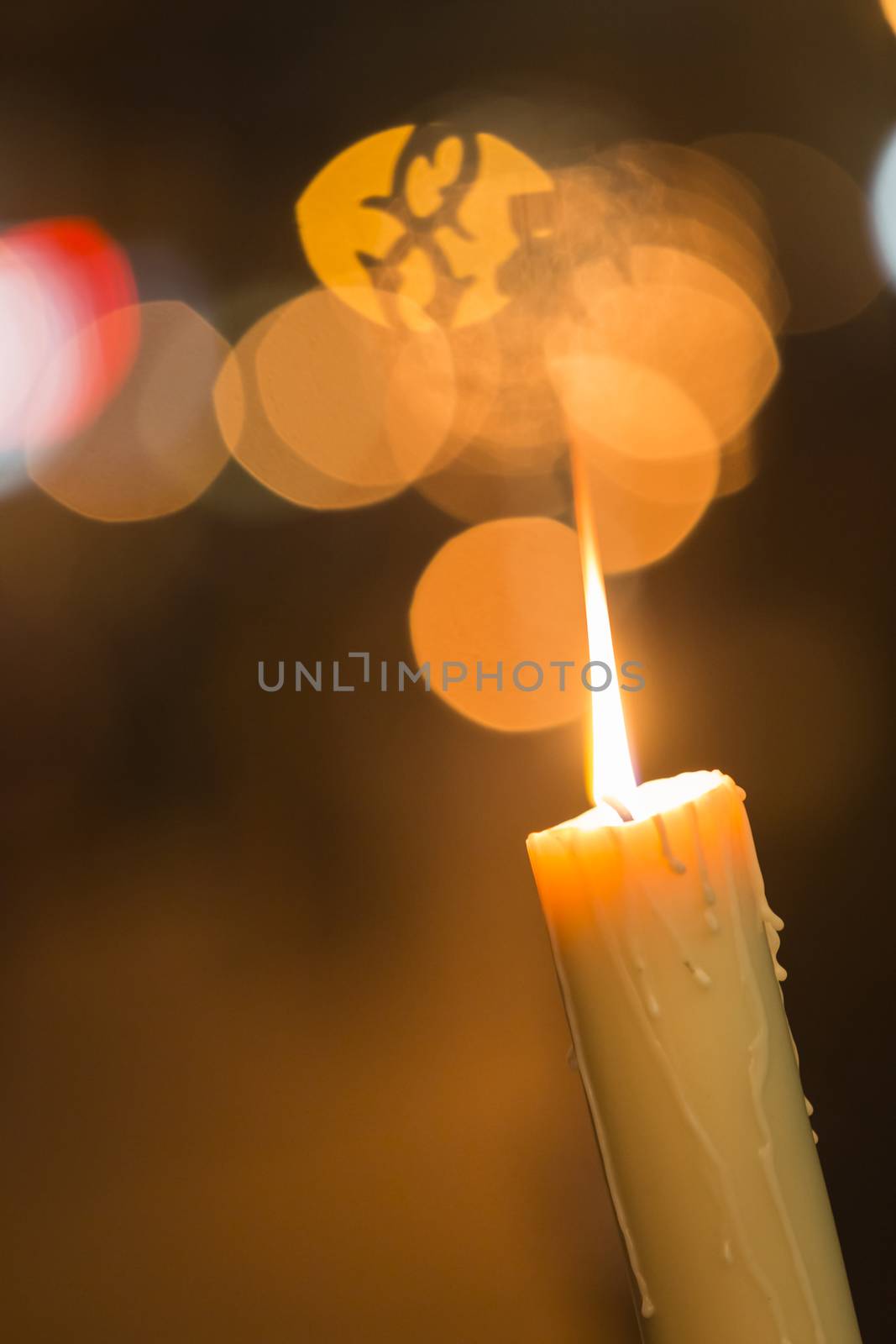 Candle light with light bokeh in the background by digicomphoto