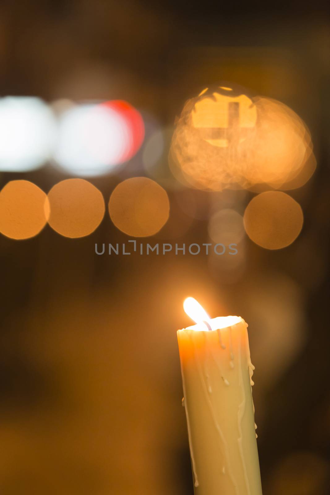 Candle light with light bokeh in the background by digicomphoto
