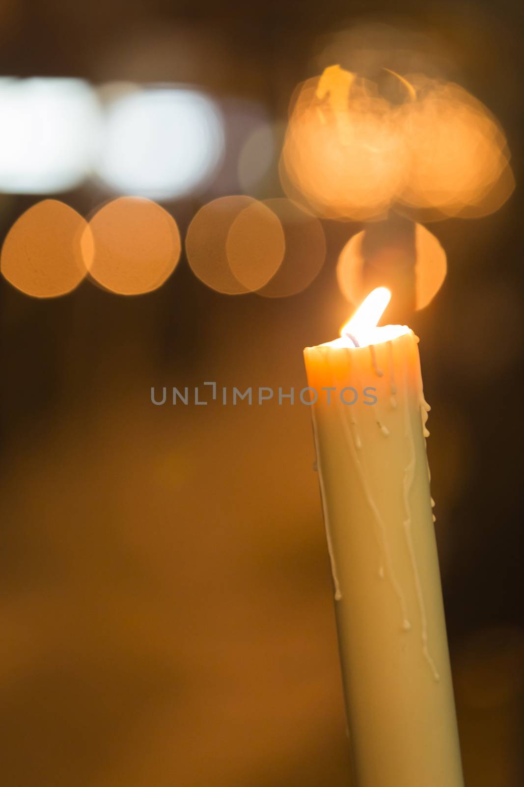 Candle light with light bokeh in the background by digicomphoto