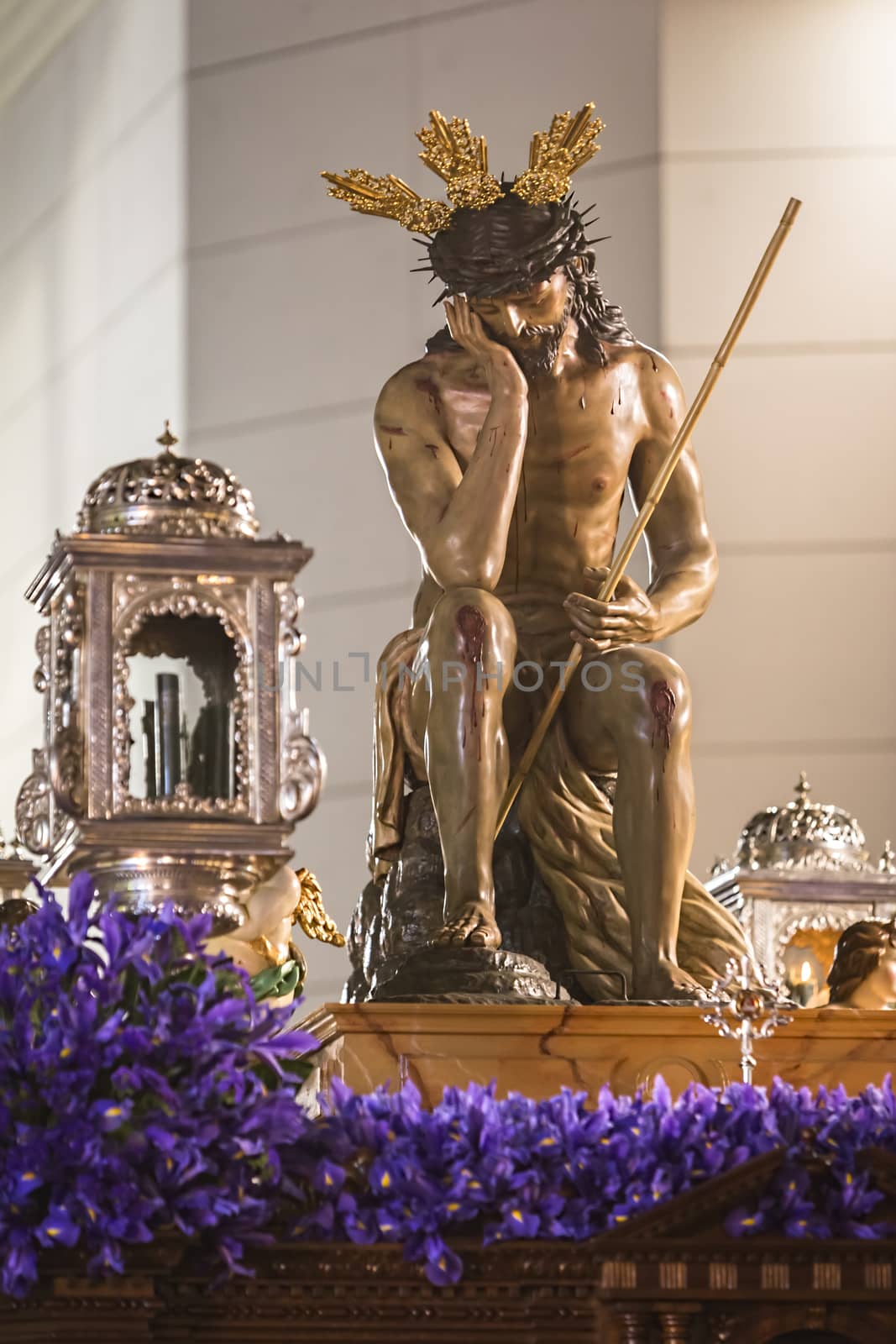 Linares, jaen province, SPAIN - March 16, 2014: Our Father Jesus of humility, It represents the moment after the flogging and derision by the guard Roman in the courtyard of the Antonia fortress in Jerusalem. It highlights his attitude exalted with his right hand resting on the cheek, pitch on her head and the other hand on your kneeduring, Holy Week in Linares, Jaen province, Andalucia, Spain