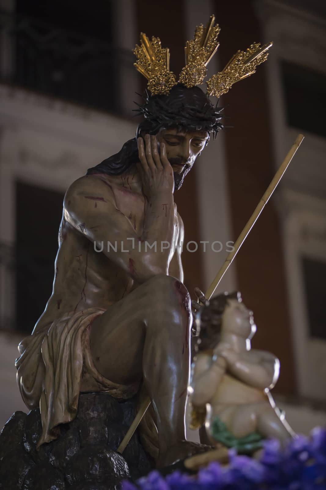 Linares, jaen province, SPAIN - March 16, 2014: Our Father Jesus of humility, It represents the moment after the flogging and derision by the guard Roman in the courtyard of the Antonia fortress in Jerusalem. It highlights his attitude exalted with his right hand resting on the cheek, pitch on her head and the other hand on your kneeduring, Holy Week in Linares, Jaen province, Andalucia, Spain