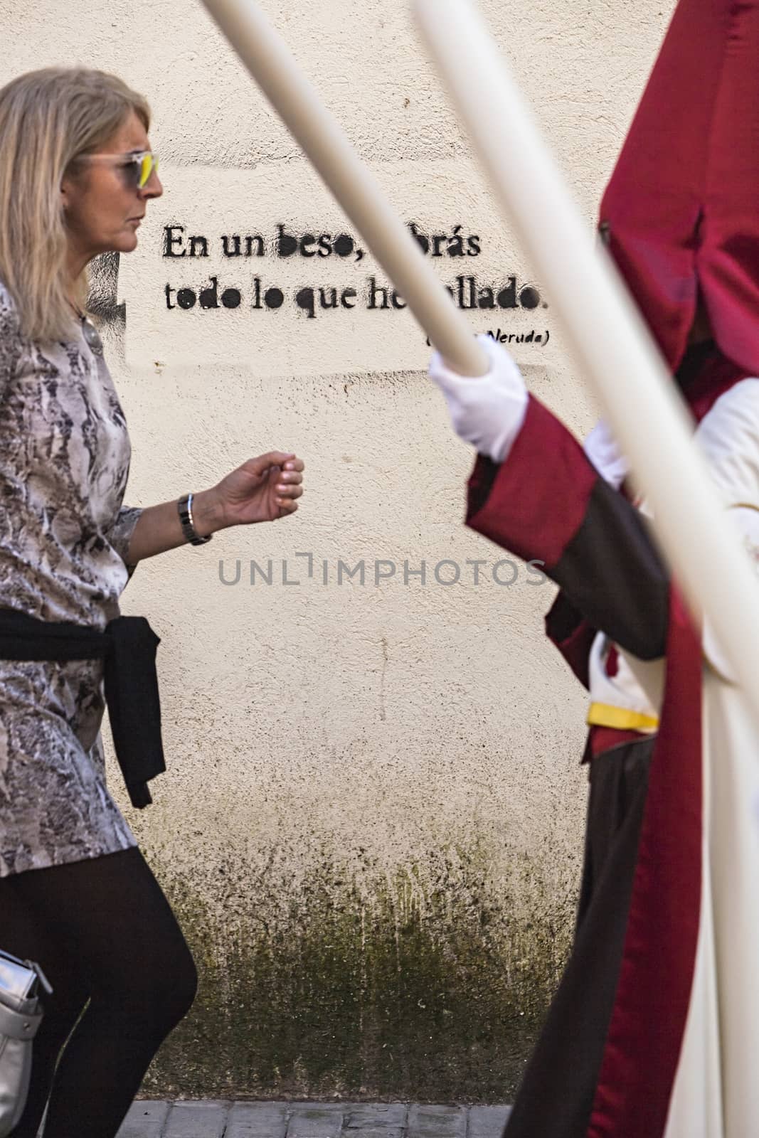 Detail penitent white holding a candle during Holy Week, Spain by digicomphoto