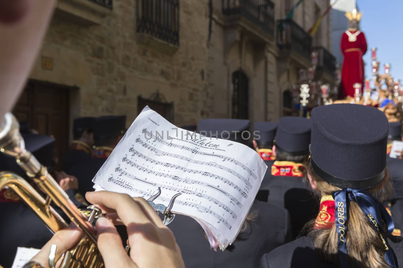 Linares, jaen province, SPAIN - March 17, 2014: Brotherhood of Jesus rescue making station of penitence, detail of the musician playing the trumpet looking a score, Linares, Jaen province, Andalusia, Spain