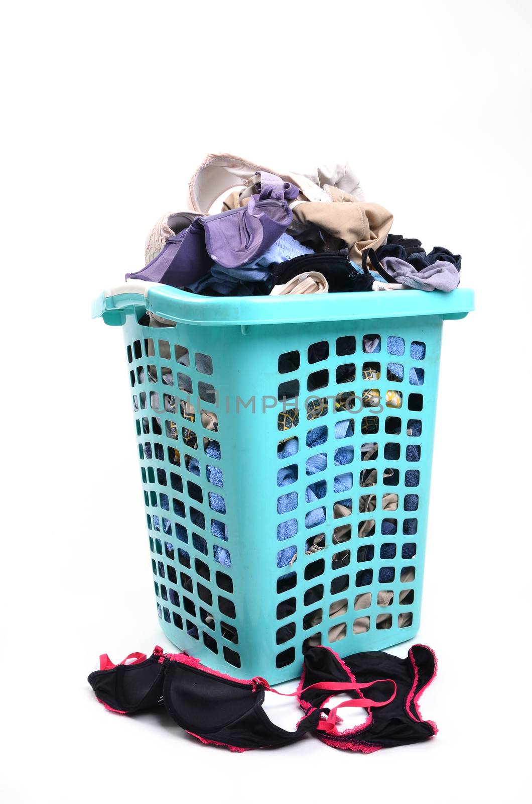 unwashed cloth in the basket on white background