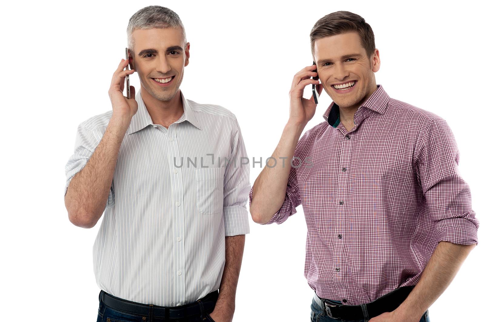 Two handsome men communicating via cellphone