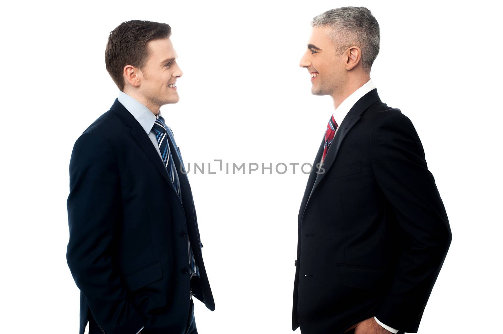 Smiling businessmen in discussion by stockyimages