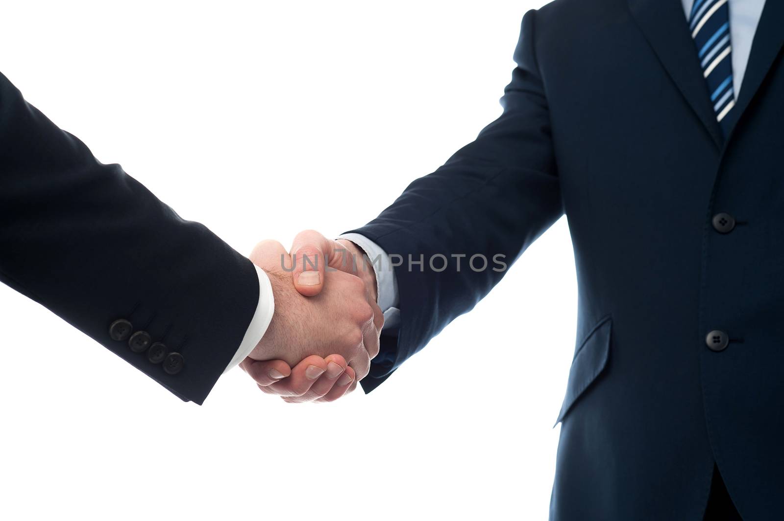 Closeup of business people shaking hands by stockyimages