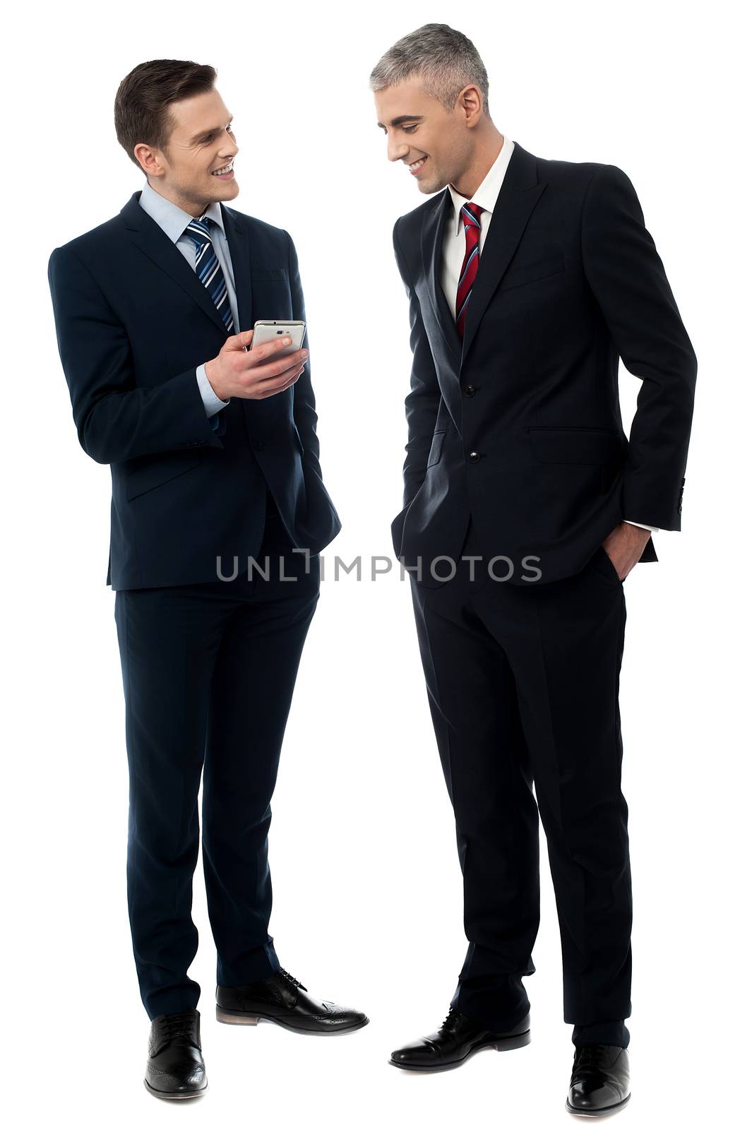 Businessmen using mobile phone by stockyimages