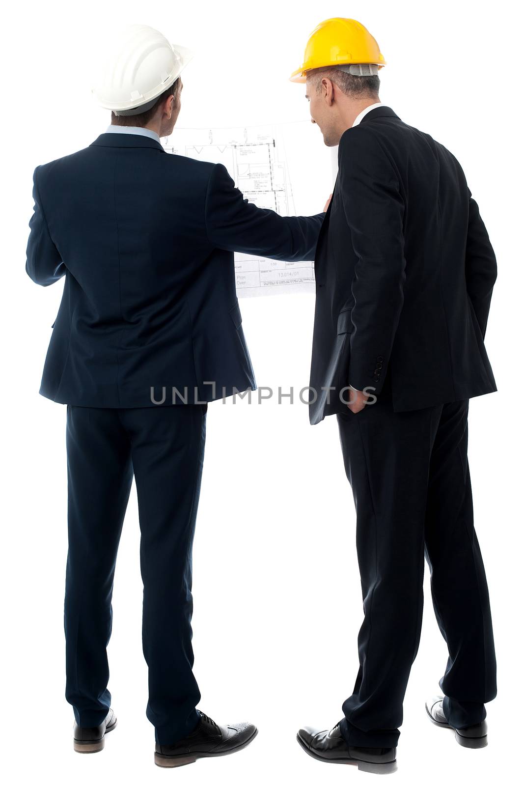 Architects discussing their building plan by stockyimages