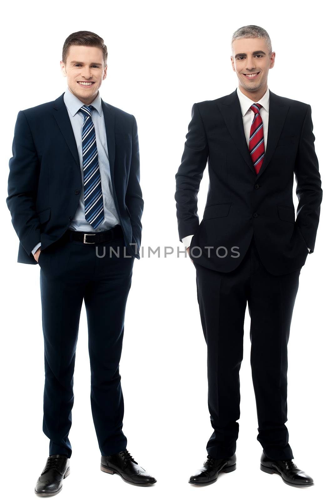 Handsome business partners posing with hands in pockets