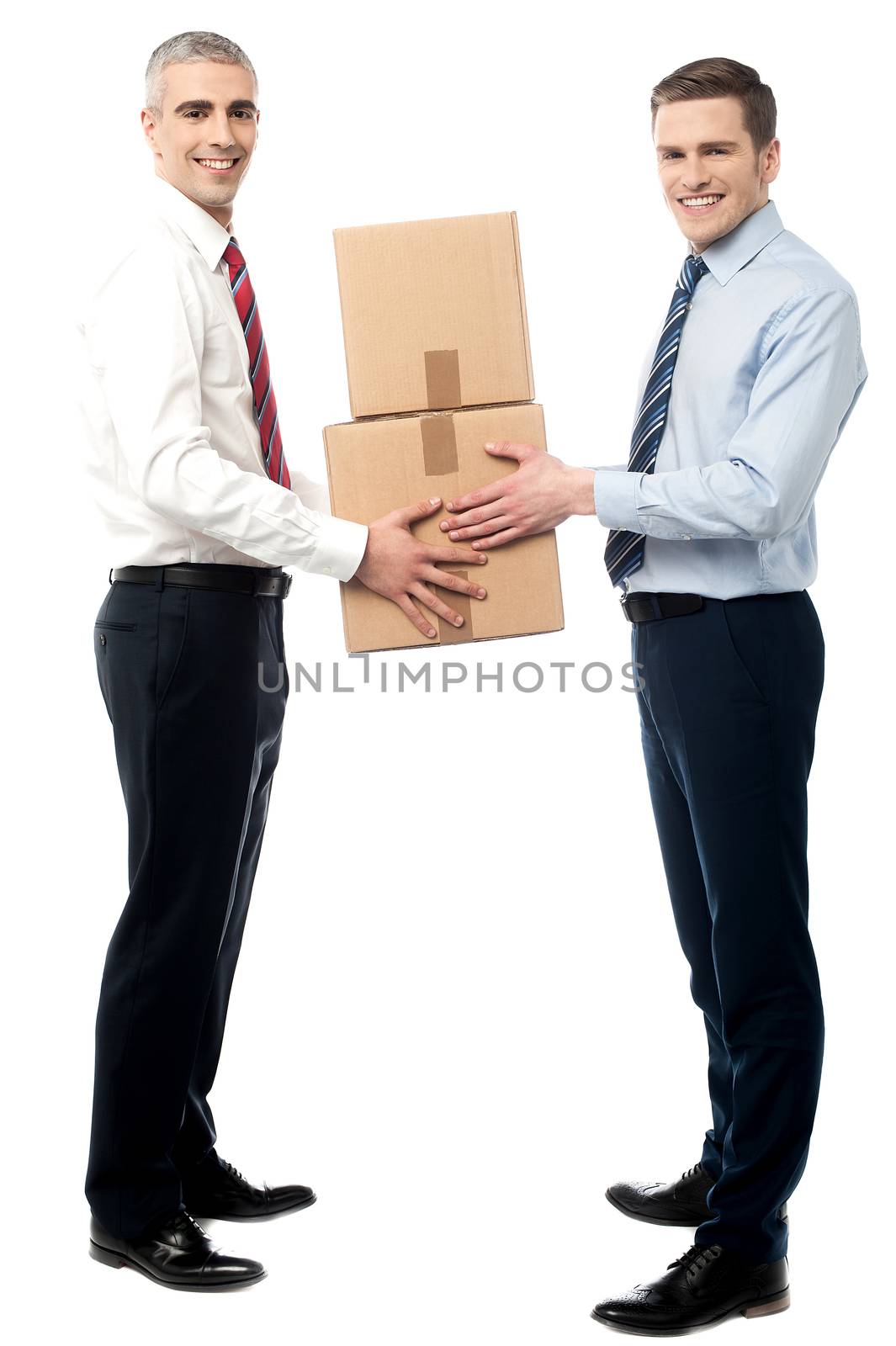 Smiling young men receive cartons boxes by stockyimages