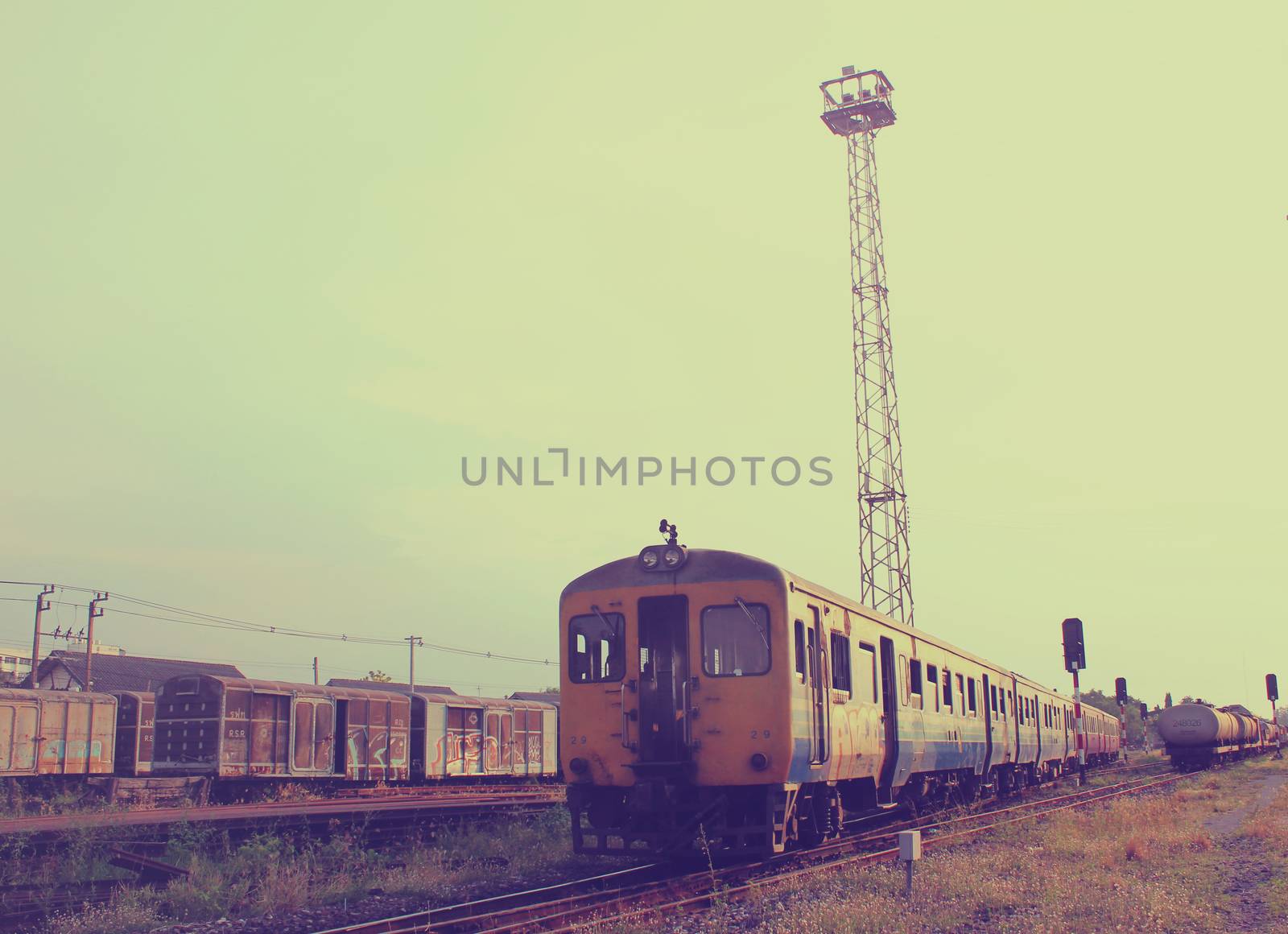 Old train on railway with retro filter effect by nuchylee