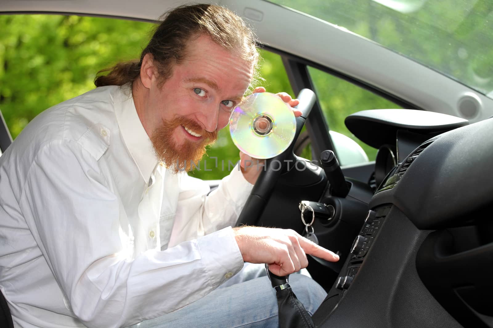 driver with CD, playing music in the car