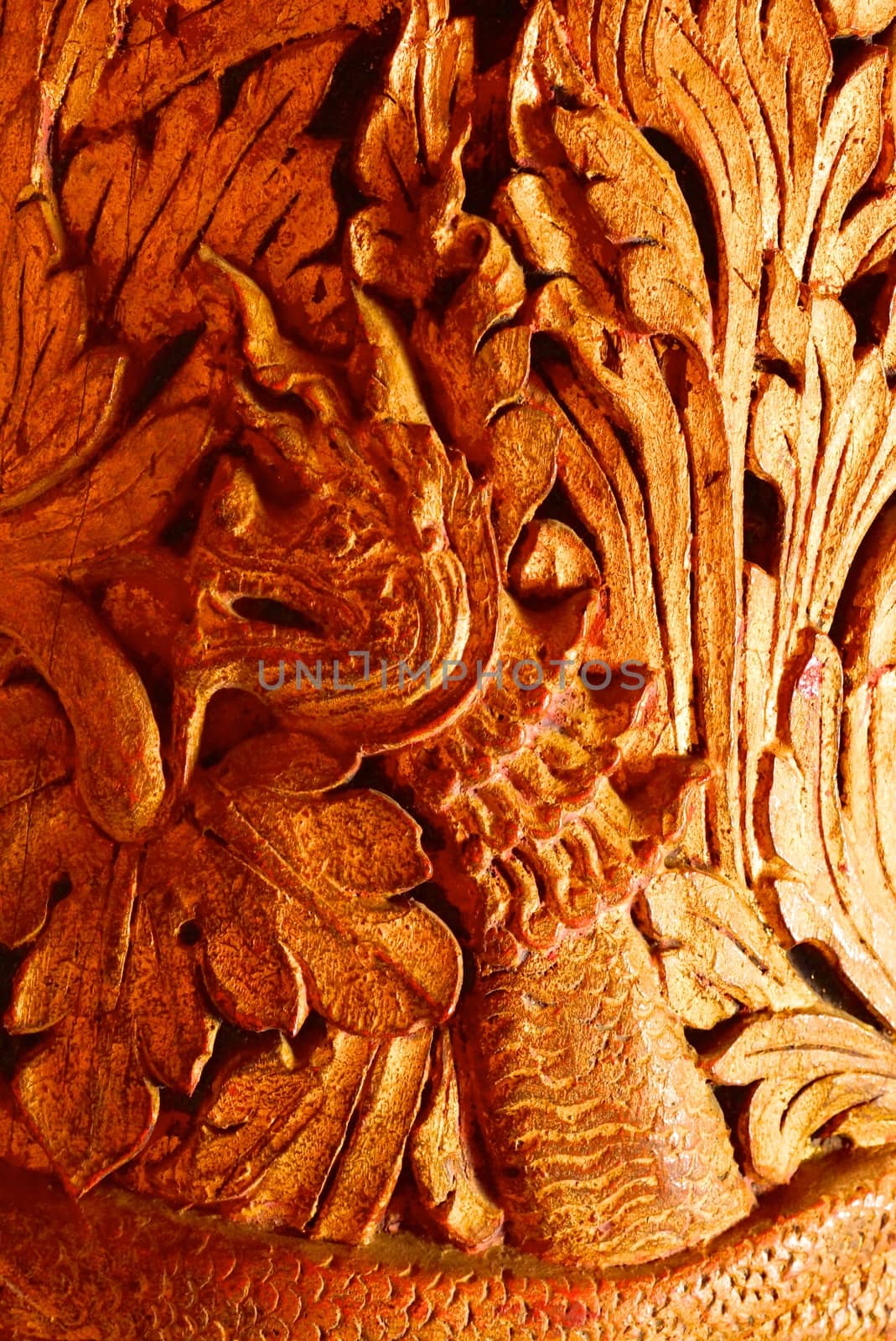 the detail of ancient thai decorated pattern that include handcraft wood carving work,gold painting and decorated with gold plate,mirror and precious stone,Lampang temple,Thailand