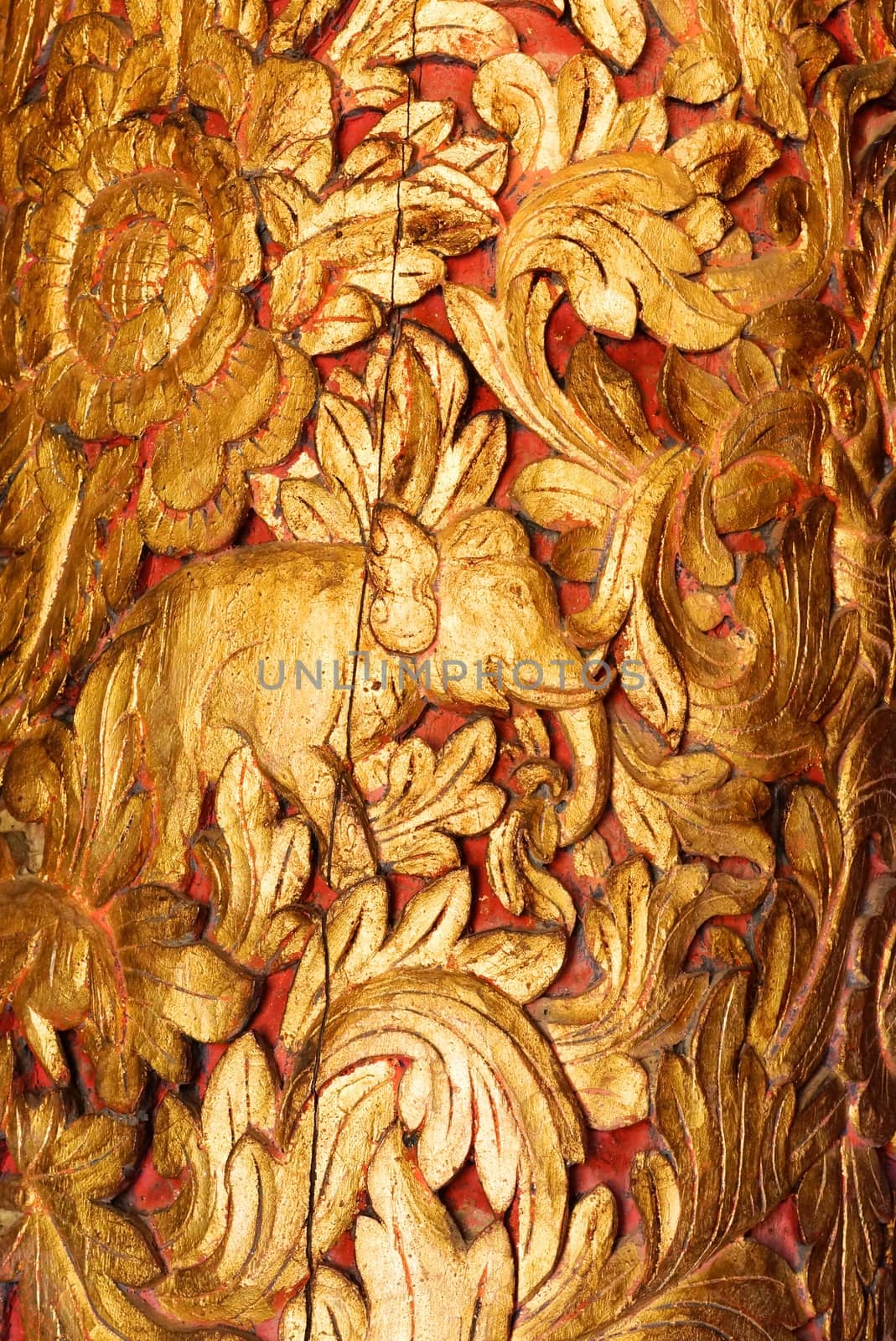 the detail of thai pattern show handmade wood carving work and decorated with gold plate,mirror and precious stone,Lampang temple,Thailand