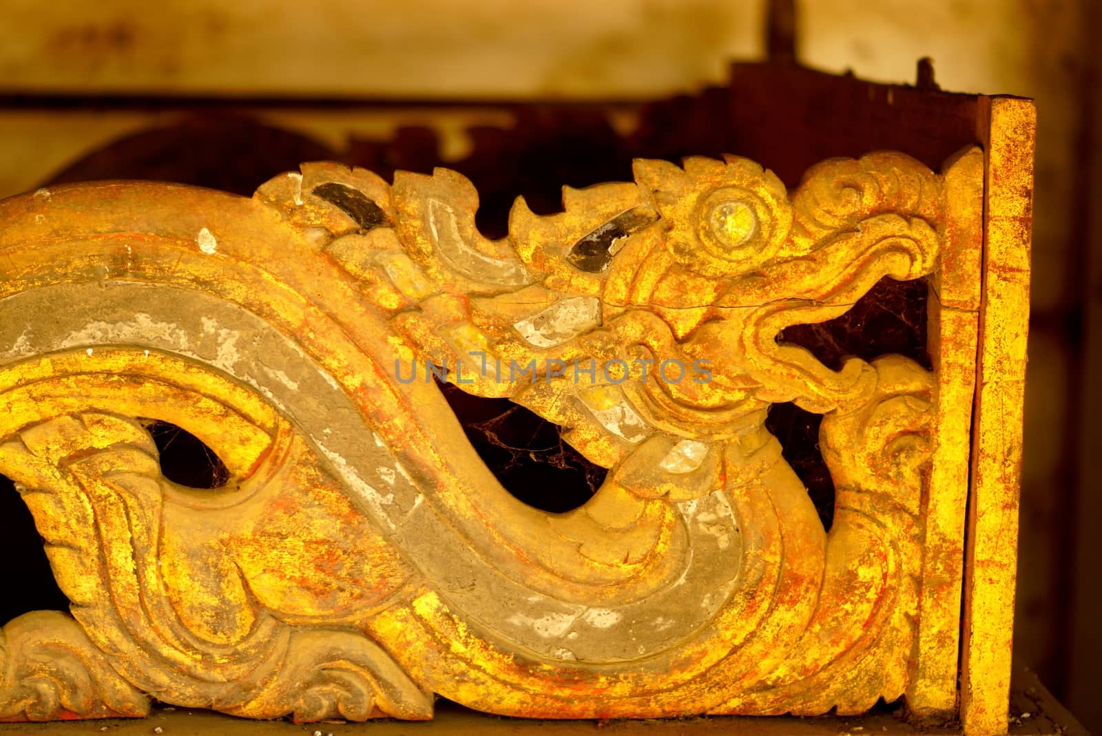 the detail of ancient thai decorated pattern that include handcraft wood carving work,gold painting and decorated with gold plate,mirror and precious stone,Lampang temple,Thailand