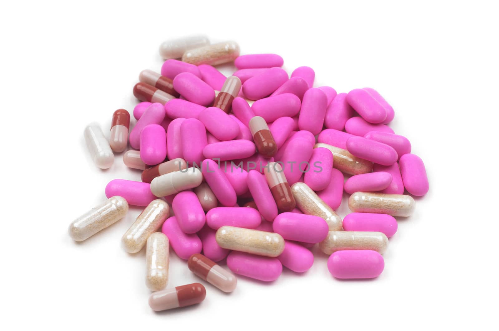 Shot of pink pills isolated on white