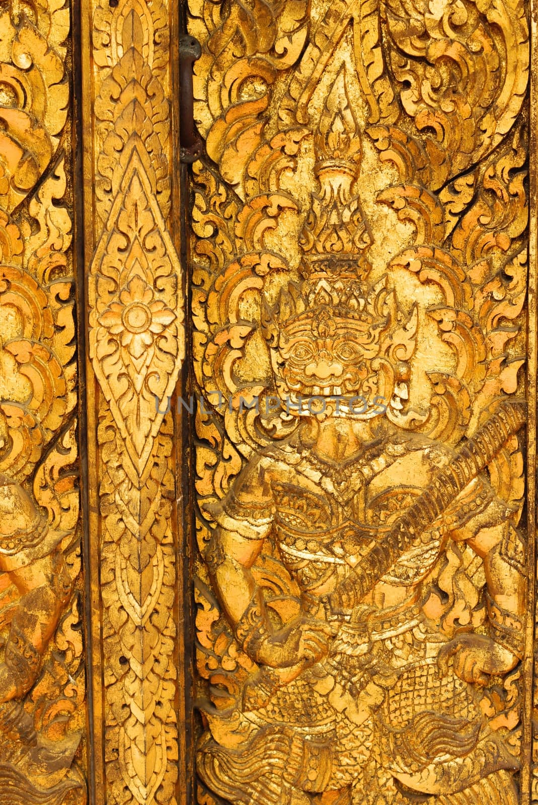 the detail of ancient thai decorated pattern that include handcraft wood carving work,gold painting and decorated with gold plate,mirror and precious stone,Lampang temple,Thailand