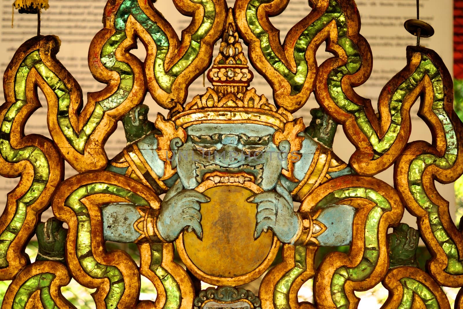the detail of ancient thai decorated pattern that include handcraft wood carving work,gold painting and decorated with gold plate,mirror and precious stone,Lampang temple,Thailand