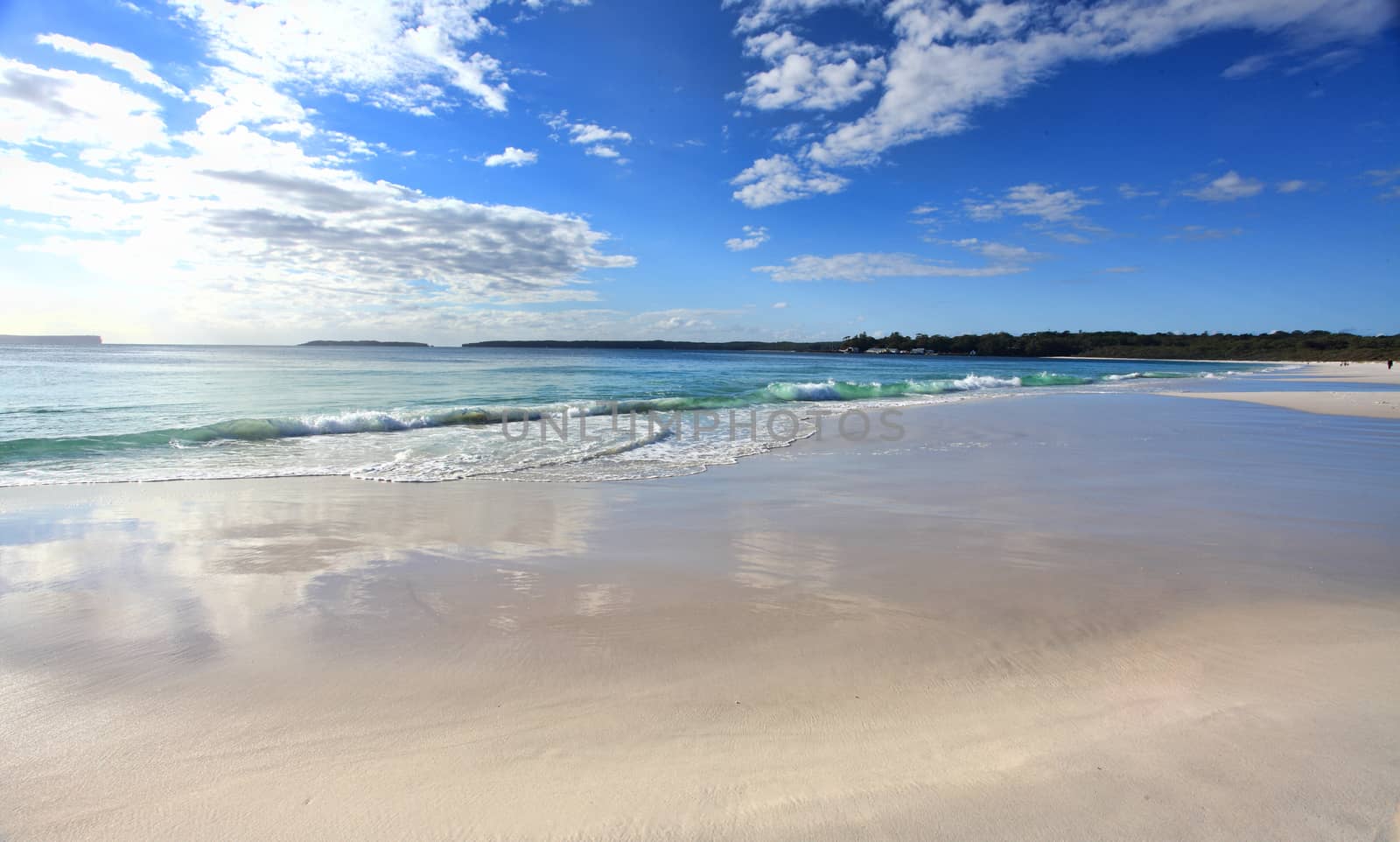 Beautiful Australian beach  in the morning with cloud reflections on the sand.