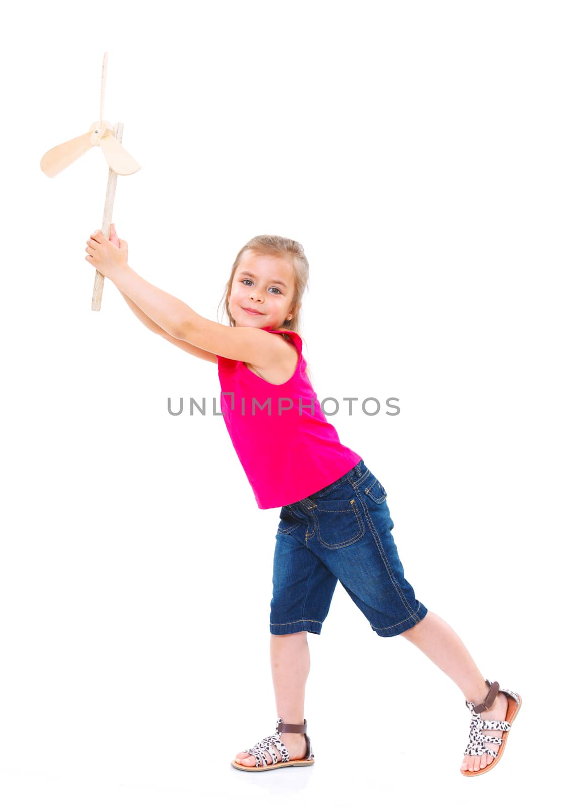 Education, childhood and ecology concept - smiling girl with wooden windmill toy.