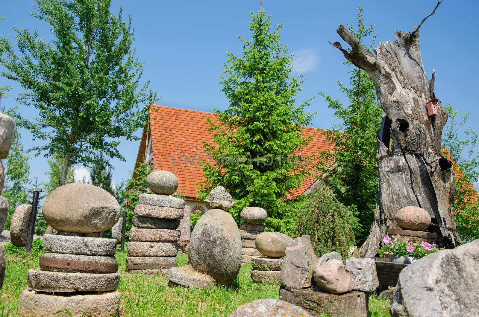 stone composition in village in summer park by sauletas