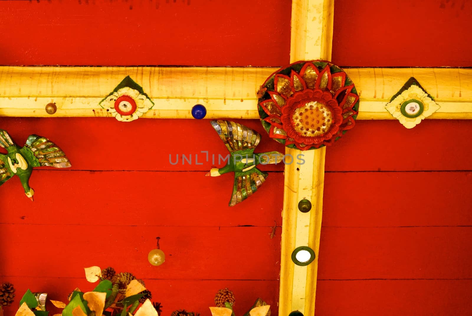 the detail of ancient thai decorated pattern that include handcraft wood carving work,gold painting and decorated with gold plate,mirror and precious stone,Lampang temple,Thailand