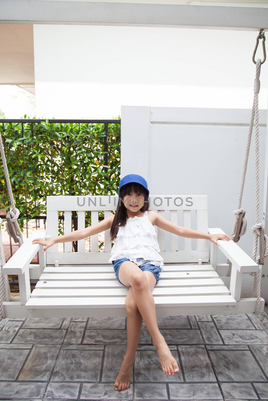 girl sitting on a swing by a454