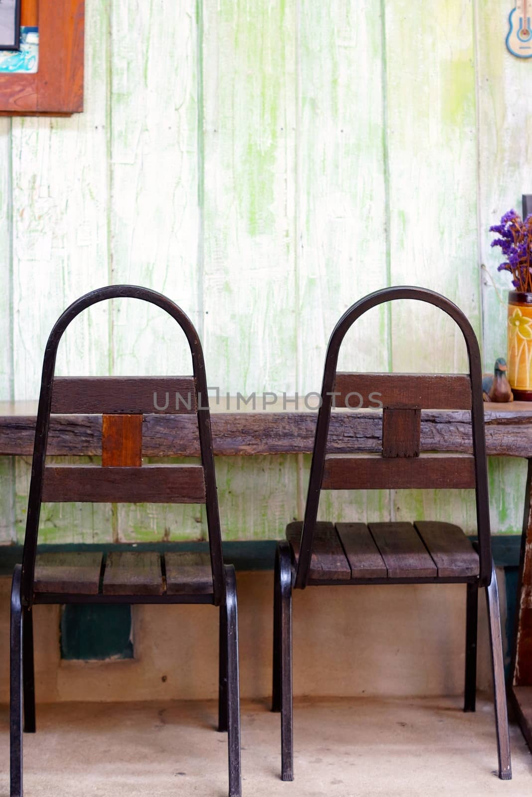 two of retro style chairs that made by wood and metal