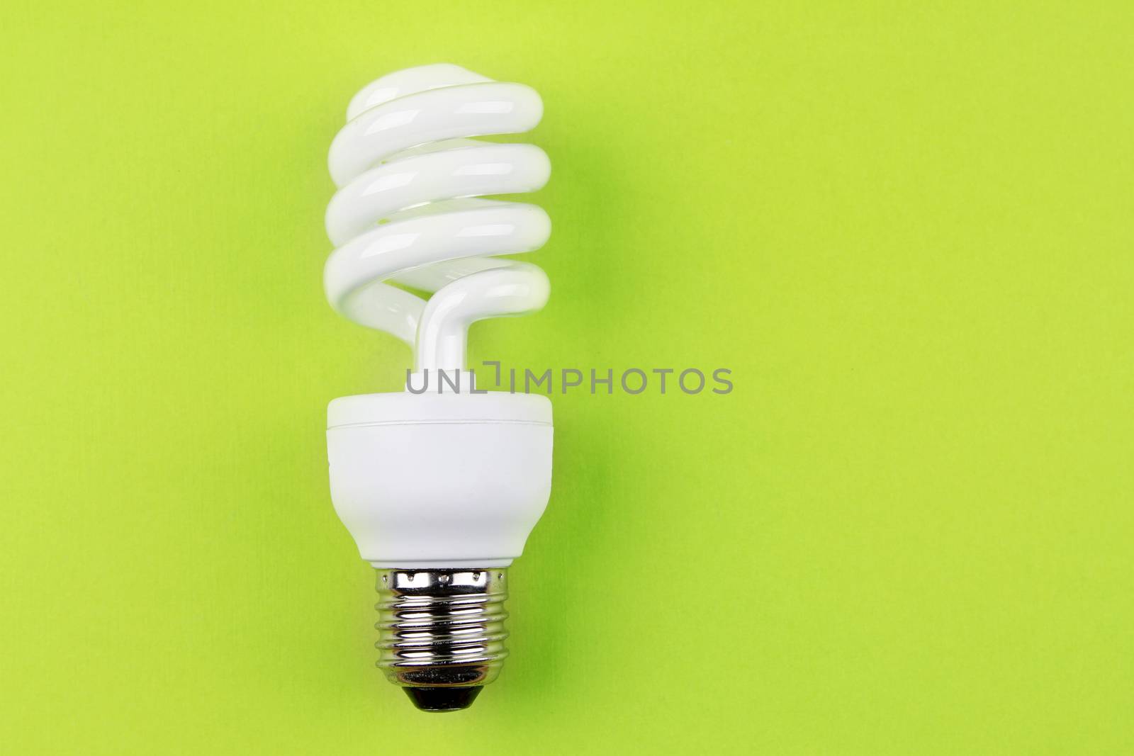 Power saving light bulb on green