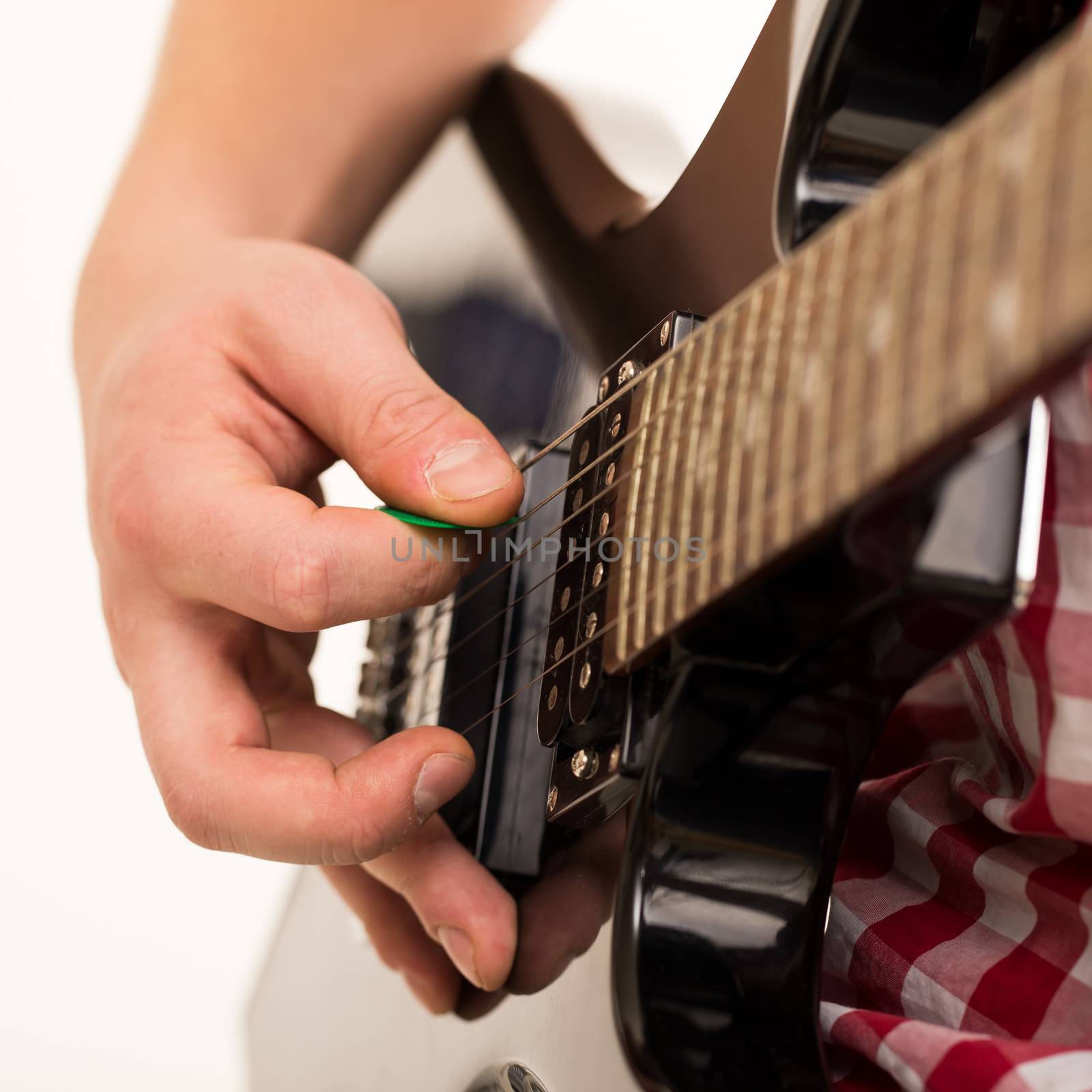 Music, close-up. Musician with electro guitar