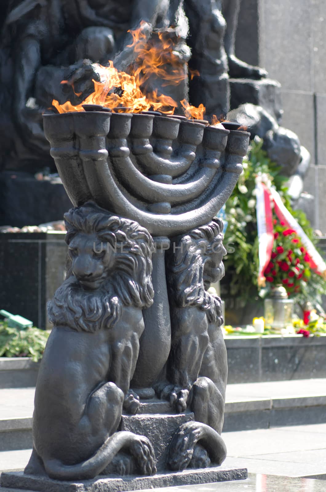 Warsaw, Poland – April 19, 2014: Celebration of the 71 anniversary of the Warsaw Ghetto Uprising. Menorah with burning flame.
