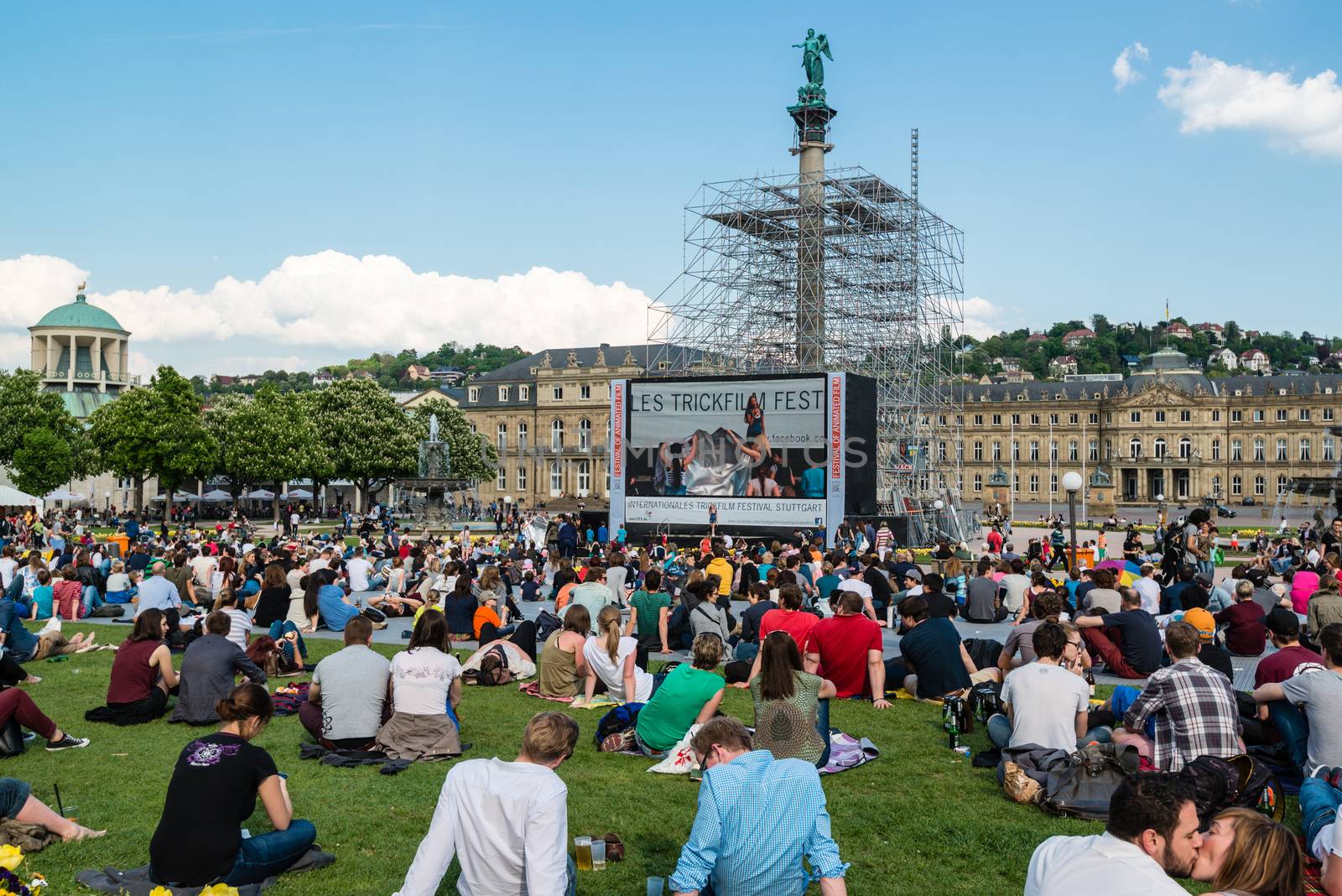 STUTTGART, GERMANY - APRIL 24, 2014: People are enjoying the open air cinema in the city center of Stuttgart on a sunny spring day during the 21st International Trickfilm Festival on April, 26,2014 in Stuttgart, Germany. Besides a special conference and movie competition, the makers are involving the broad audience through a public screening of movies and games competitions.