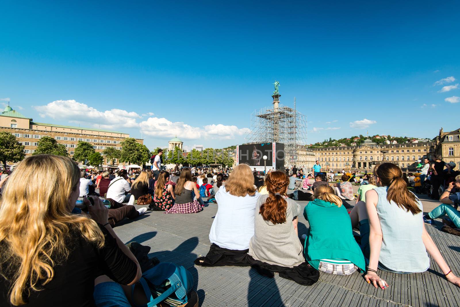 STUTTGART, GERMANY - APRIL 24, 2014: People are enjoying the open air cinema in the city center of Stuttgart on a sunny spring day during the 21st International Trickfilm Festival on April, 26,2014 in Stuttgart, Germany. Besides a special conference and movie competition, the makers are involving the broad audience through a public screening of movies and games competitions.