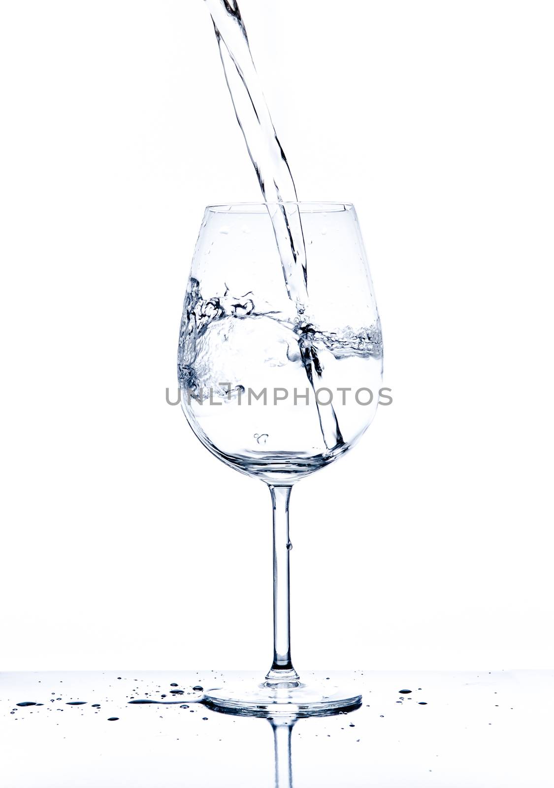 Glass with the stream of dinking water by martinm303