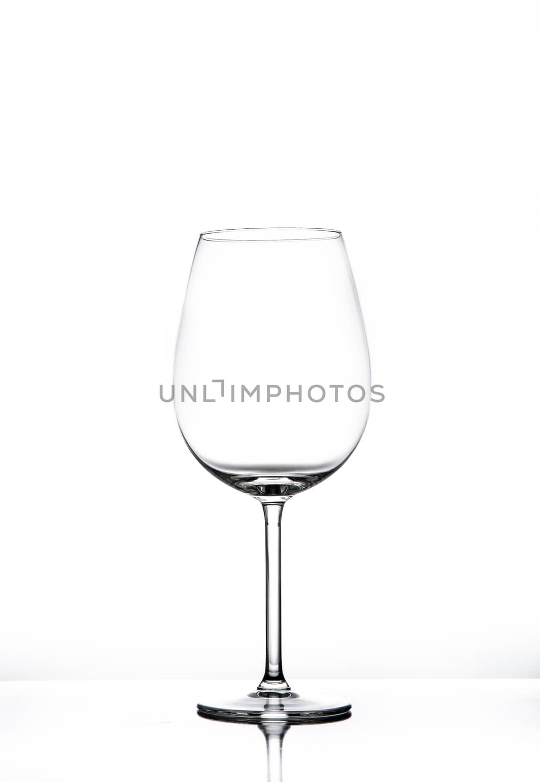 Empty wine glass isolated on white seamless background