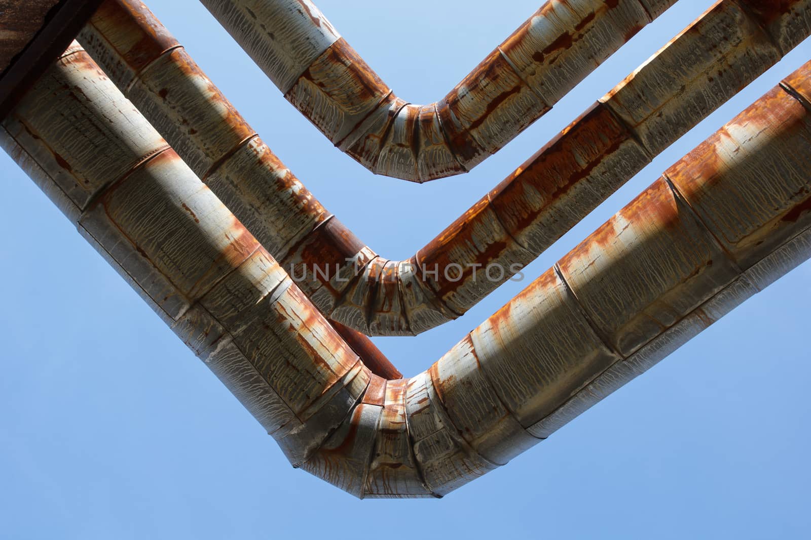 old rusty pipes against a blue sky