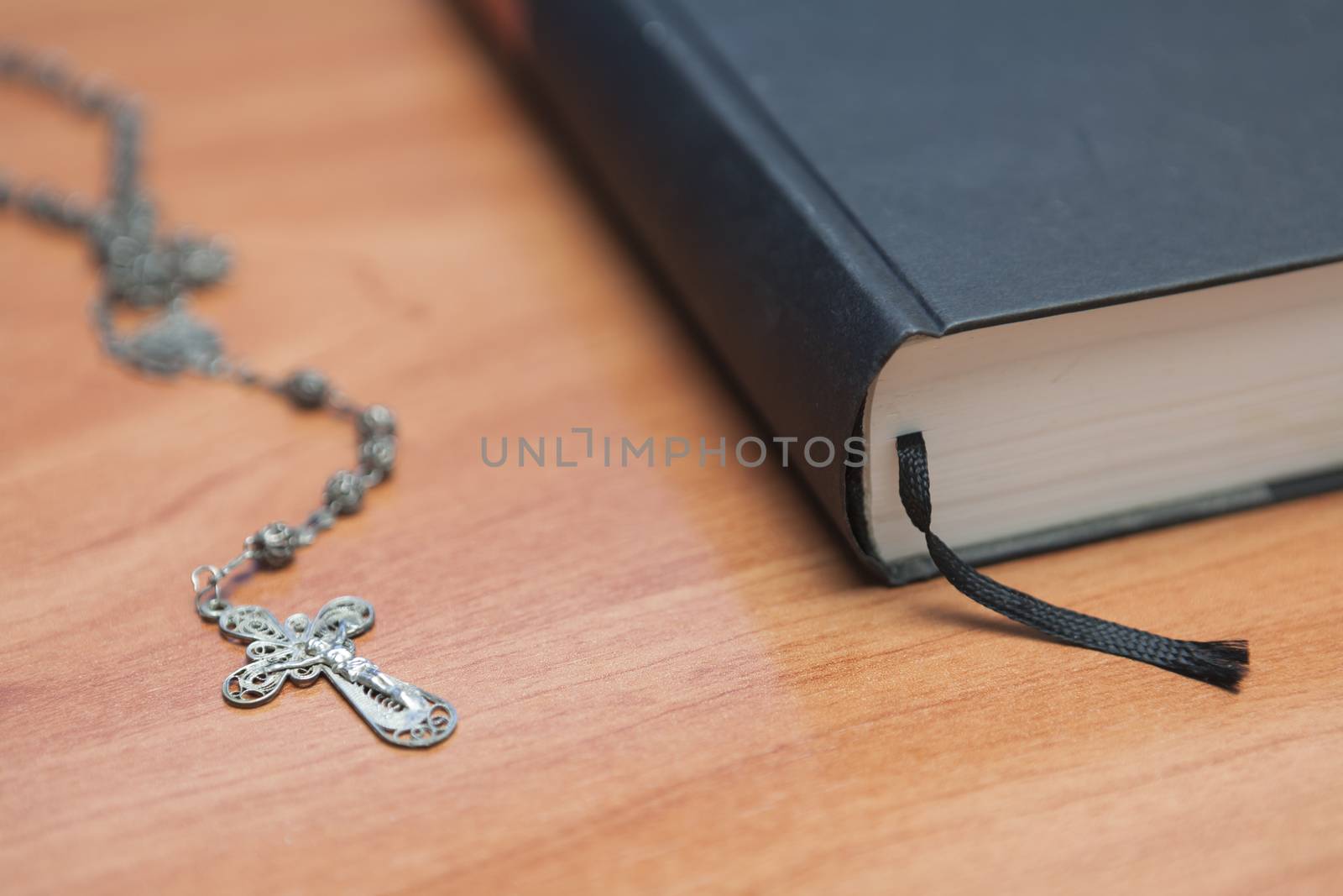 Rosary beads and a holy bible by digicomphoto